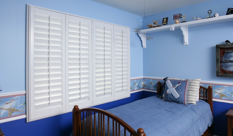 Blue kids bedroom with white plantation shutters in Clearwater 